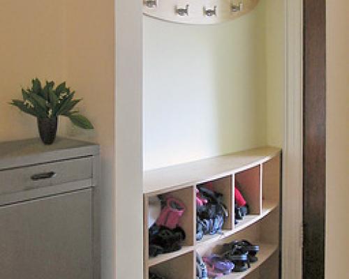 A 45 degree view of shelves and a coat rack above them.