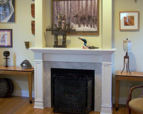 A fireplace with a white, wood mantelpiece.